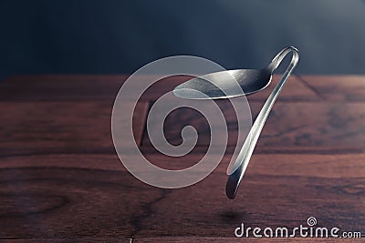 Psychokinesis concept with bent spoon Stock Photo