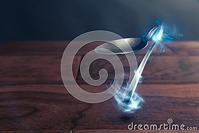 Psychokinesis concept with bent spoon Stock Photo