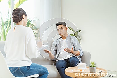 Psychologist consulting and psychological therapy session. Man in stress emotionally telling about his depression and problems to Stock Photo