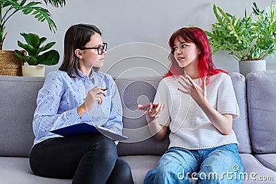 Psychologist counseling teenage female, individual therapy in doctors office. Stock Photo