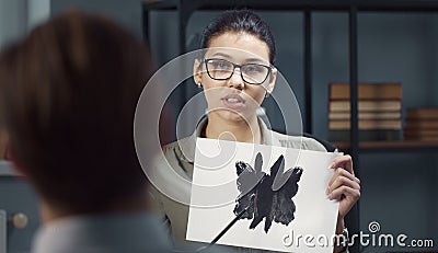 Psychologist showing Rorschach Inkblot card Stock Photo