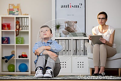 Psychologist talking with depressed boy Stock Photo