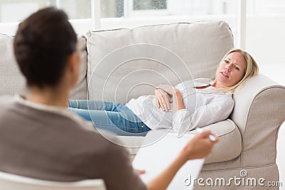 Psychologist talking to depressed female patient Stock Photo