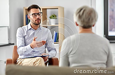 Psychologist talking to senior woman patient Stock Photo