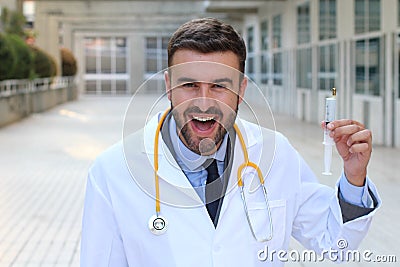 Psychopathic looking doctor holding a syringe Stock Photo