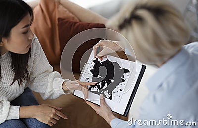 Psychotherapist Testing Female Patient Showing Inkblot Picture Sitting In Office Stock Photo