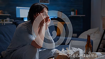 Psychotic alone woman sitting on couch feeling disappointed Stock Photo