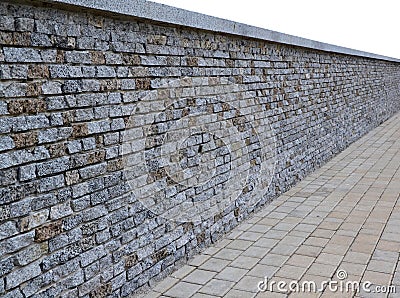 Pt-Isolated wall of bricks with granite paving tiles in perspective Stock Photo