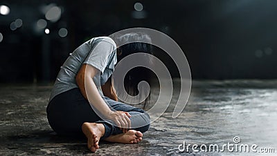 PTSD Mental health concept. Post Traumatic Stress Disorder. The depressed woman sitting alone on the floor in the dark room backgr Stock Photo