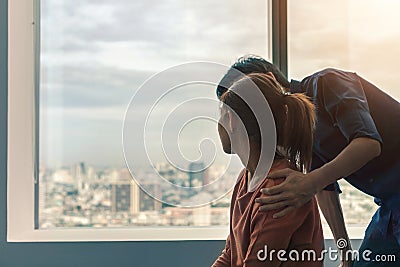 PTSD Mental health concept, Psychologist sitting and touch young depressed asian woman for encouragement near window with low Stock Photo