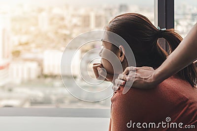 PTSD Mental health concept, Psychologist sitting and touch young depressed asian woman for encouragement near window with low Stock Photo