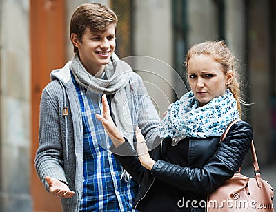 Public harassment: man chasing irritated girl Stock Photo