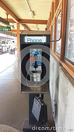 Public phone booth on elevated subway train platform Editorial Stock Photo