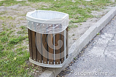 Public rubbish bin in a park. Wooden litter bin in public area Stock Photo