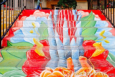 Public staircase on the street, decorated anonymously with painted flowers Stock Photo