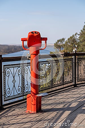 Public stationary binoculars on the banks of the river in summer Stock Photo