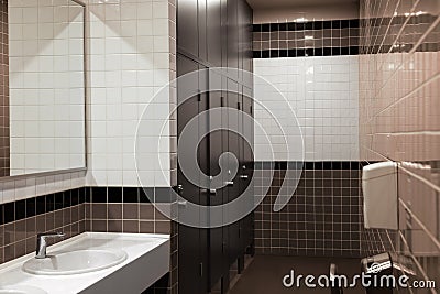 Public toilet interior with sinks, stalls and mirror Stock Photo