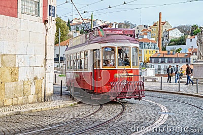 Public tram on the streets of the Alfama neighbourhood, the old quarter of Lisbon, Portugal Editorial Stock Photo