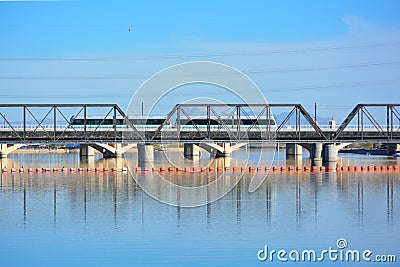 Public Transit Light Rail Train Crossing Bridge over Water Stock Photo