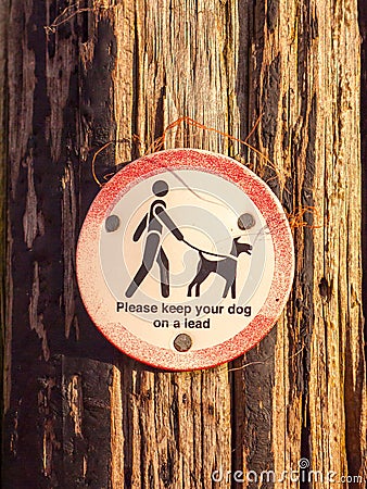 Public walking wooden sign post dog sign please keep your dog on Stock Photo