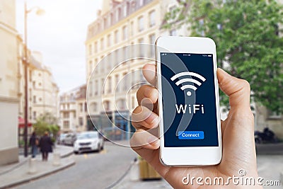 Public WiFi hotspot connection, city street, access internet on smartphone Stock Photo