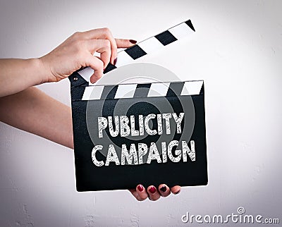 Publicity Campaign. Female hands holding movie clapper Stock Photo