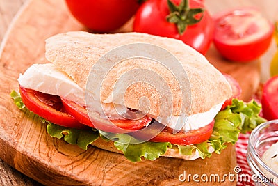 Puccia bread with mozzarella and tomato. Stock Photo