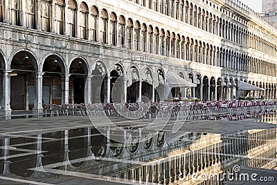 Puddle which reflects Procuratie Vecchie in Piazza San Marco in Venice Editorial Stock Photo