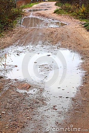 Puddles on a dirty country road Stock Photo