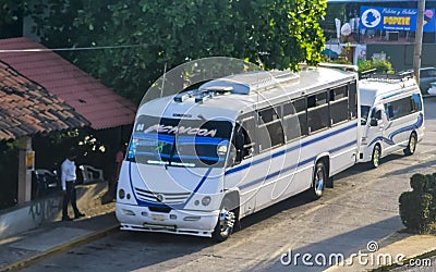 Various colorful buses tour bus transport in Puerto Escondido Mexico Editorial Stock Photo