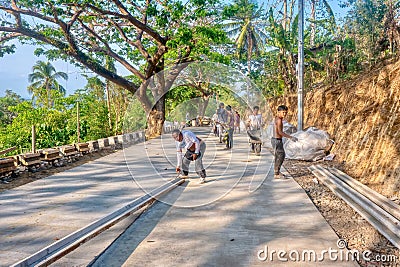 Filipino workers on a road construction site on Mindoro Island, Philippines. Editorial Stock Photo