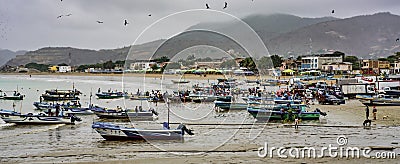 Puerto Lopez, Ecuador - September 12, 2018 - Fishermen finish their day fixing nets, cleaning boats, and talking with Editorial Stock Photo