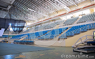 Puerto Princesa, the Philippines - 27 Nov 2018: empty stadium with plastic chairs and stage. Sport coliseum building Editorial Stock Photo