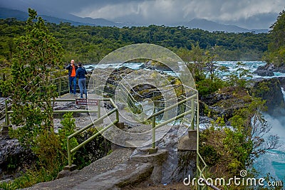PUERTO VARAS, CHILE, SEPTEMBER, 23, 2018: Outdoor view of Unidentified people enjoying the beautiful waterfalls in Editorial Stock Photo