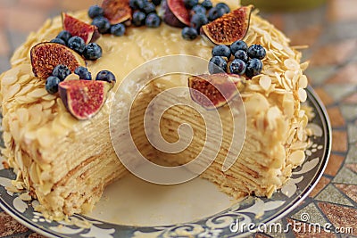Puff cake, sponge cake with figs and blueberries, sectional view, mouth-watering dessert Stock Photo