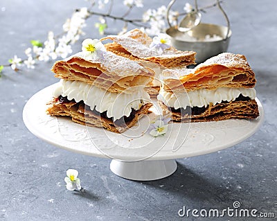 Puff pastry cake with whipped sour cream and cherry preserves. Stock Photo