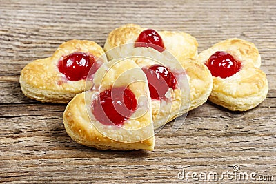 Puff pastry cookies in heart shape filled with cherries Stock Photo
