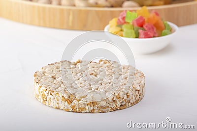 Puffed exploded wheat grains on candied fruit background Stock Photo