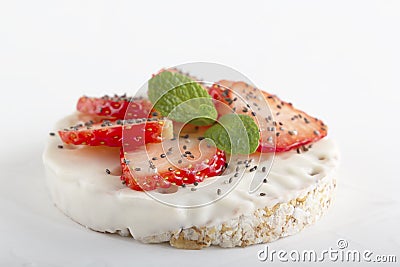 Puffed exploded wheat grains with white chocolate frosting with chopped strawberries, chia seeds and mint leaves Stock Photo