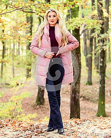 Puffer fashion concept. Outfit prove puffer coat can look stylish. Girl fashionable blonde walk in park. Jackets Stock Photo