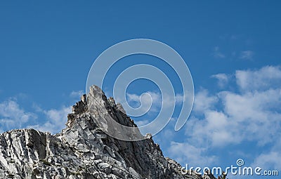 Puffs of Clouds Pass Ragged Peak in Yosemite Stock Photo