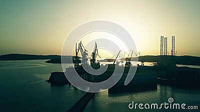 PULA, CROATIA - AUGUST 5, 2017. Aerial view of the shipyard silhouette at sunset Editorial Stock Photo