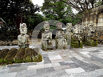 Ancient sculptures of kings made of stone in a cemetery of Lake Toba, Pulau Samosir. Indonesia Editorial Stock Photo