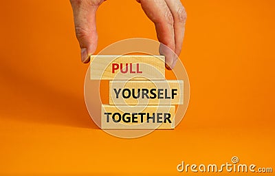 Pull yourself together symbol. Wooden blocks with words `Pull yourself together`. Beautiful orange background. Copy space. Stock Photo