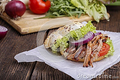 Pulled pork burger with coleslaw tomato, onion and fresh bread. Stock Photo