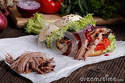 Pulled pork burger with coleslaw tomato, onion and fresh bread. Stock Photo