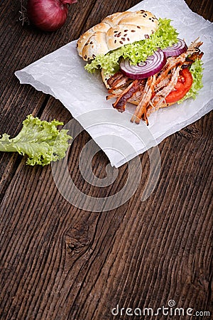 Pulled pork burger with coleslaw tomato, onion and fresh bread. Stock Photo