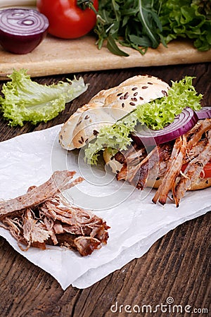 Pulled pork burger with coleslaw tomato, onion and fresh bread. Stock Photo