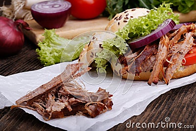 Pulled pork burger with coleslaw tomato, onion and fresh bread. Stock Photo