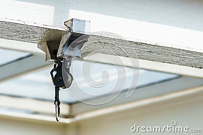 The pulley is mounted on the beam with glass roof. Stock Photo